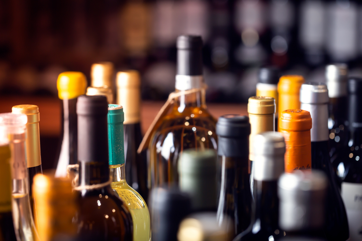 The tops of a table full of liquor bottles