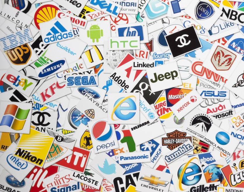 Business logo stickers from various companies in a pile